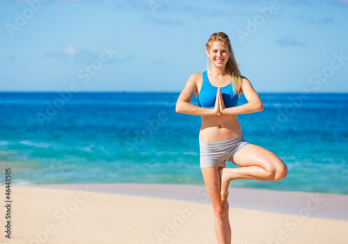 Beautiful Woman Practicing Yoga on the Beach in Hawaii
