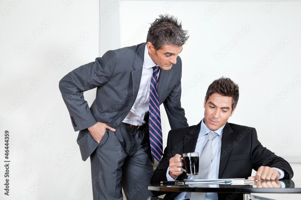 Businessman With Coffee Cup In A Meeting With Colleague Businessman With Coffee Cup In A Meeting With Colleague