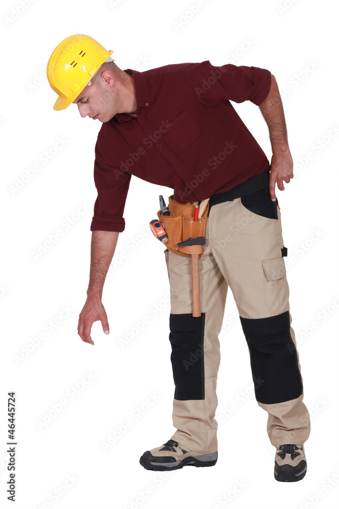 Construction worker reaching down to empty copyspace Construction worker reaching down to empty copyspace