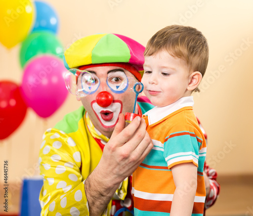 joyful kid with clown on bi...