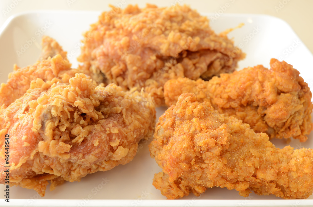 Golden brown fried chicken in white plate