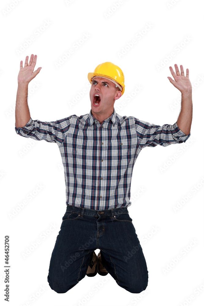 Laborer sitting on his knees screaming