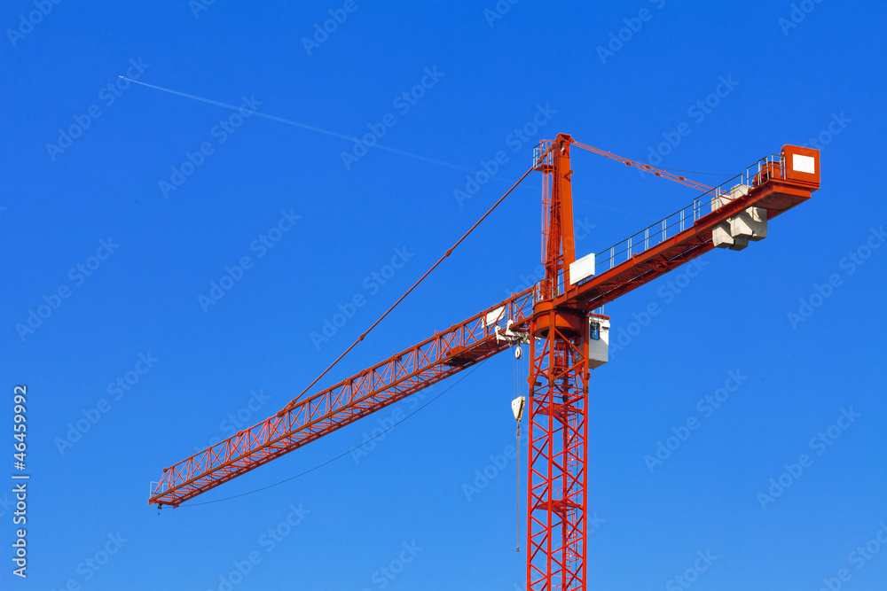 Red construction crane against the blue sky. Red construction crane against the blue sky.