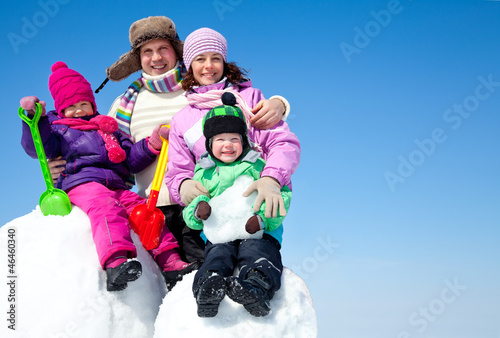 Happy family making snowman