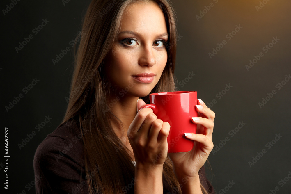 beautiful young woman with cup of coffee, on brown background beautiful young woman with cup of coffee, on brown background