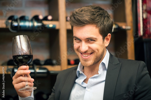 Young man tasting red wine