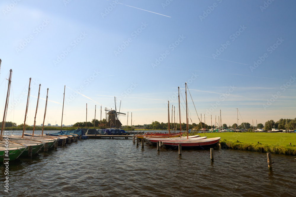 Dutch landscape of small harbor. Summer blue sky.