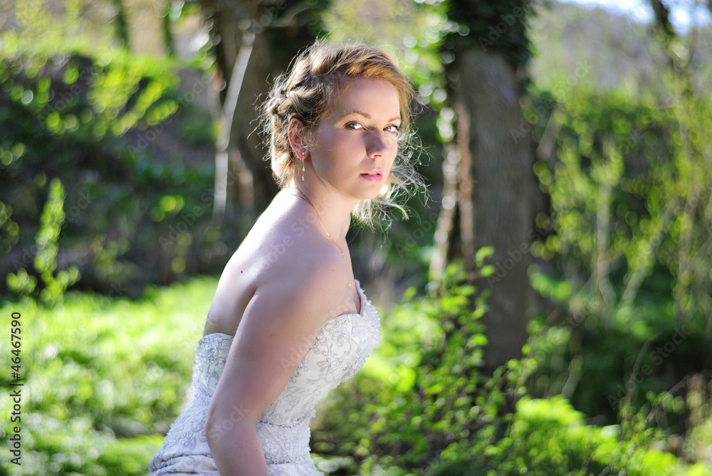 beautiful girl bride in green wood by summer