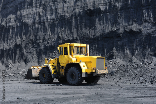Yellow bulldozer goes in the coal mine