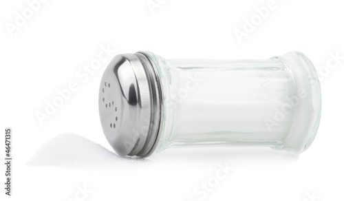 Glass saltcellar with salt on white background