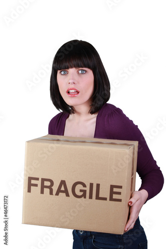 Woman carefully holding fragile box © auremar