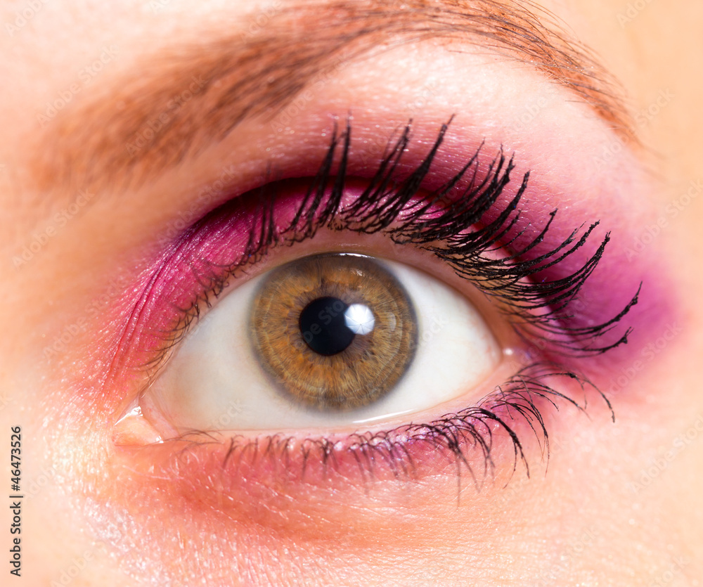 Obraz premium Brown eye with bright pink and violet makeup