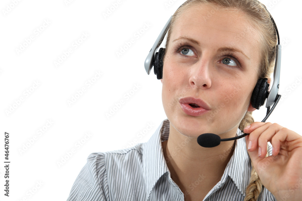 Blond call center worker helping customer over the phone Blond call center worker helping customer over the phone