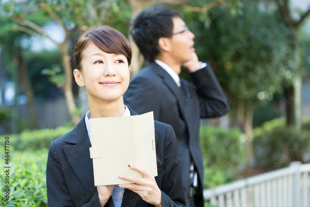 Young asian smiling businesswoman and businessman Young asian smiling businesswoman and businessman