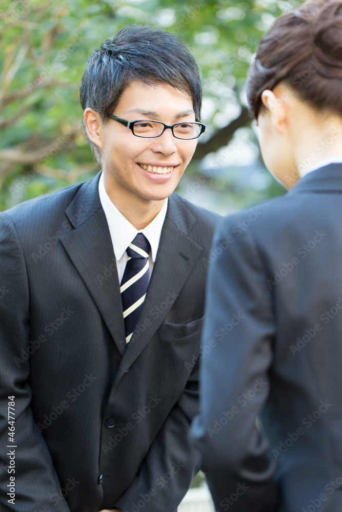 Young asian smiling businesswoman and businessman Young asian smiling businesswoman and businessman