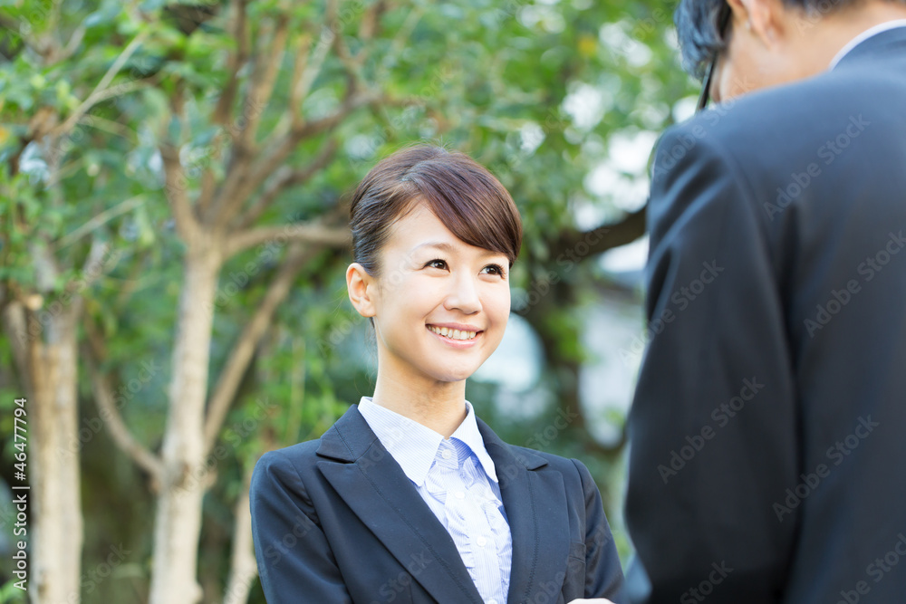 Young asian smiling businesswoman and businessman Young asian smiling businesswoman and businessman
