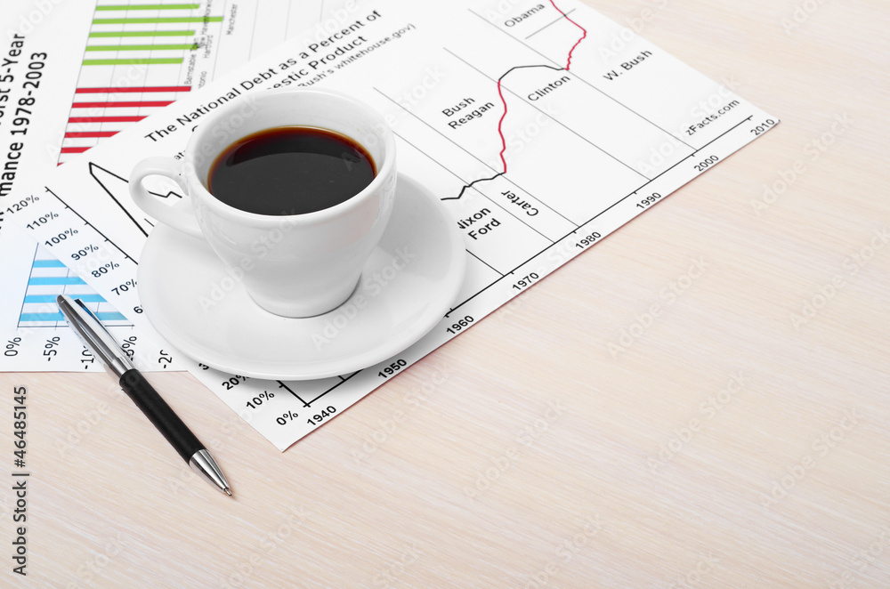 Accounting. Cup of coffee on document. chart and diagram Accounting. Cup of coffee on document. chart and diagram