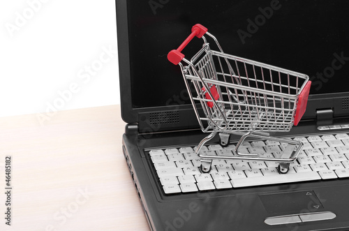 Online shopping. trolley on laptop