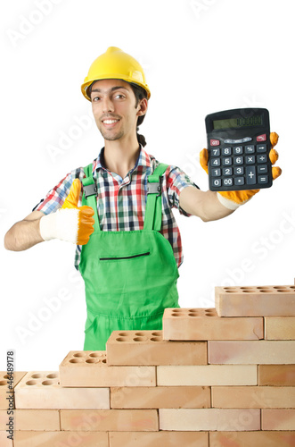 Expensive construction concept with builder and calculator photo