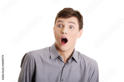 Young man with surprise expression on his face photo