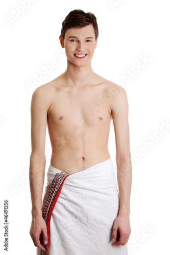Handsome, happy young man with the towel