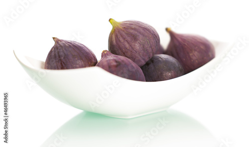 Figs on plate isolated on white background.