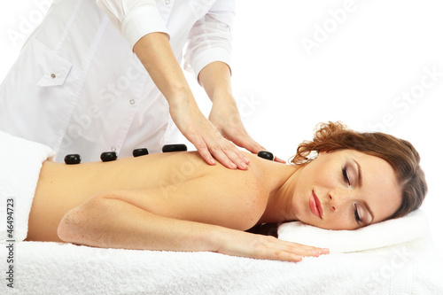 beautiful young woman in spa salon getting massage with spa