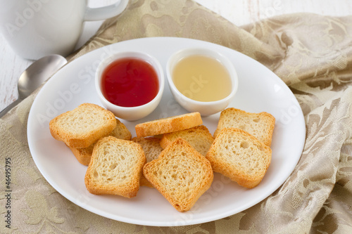 mini toasts with jam and honey in bowls