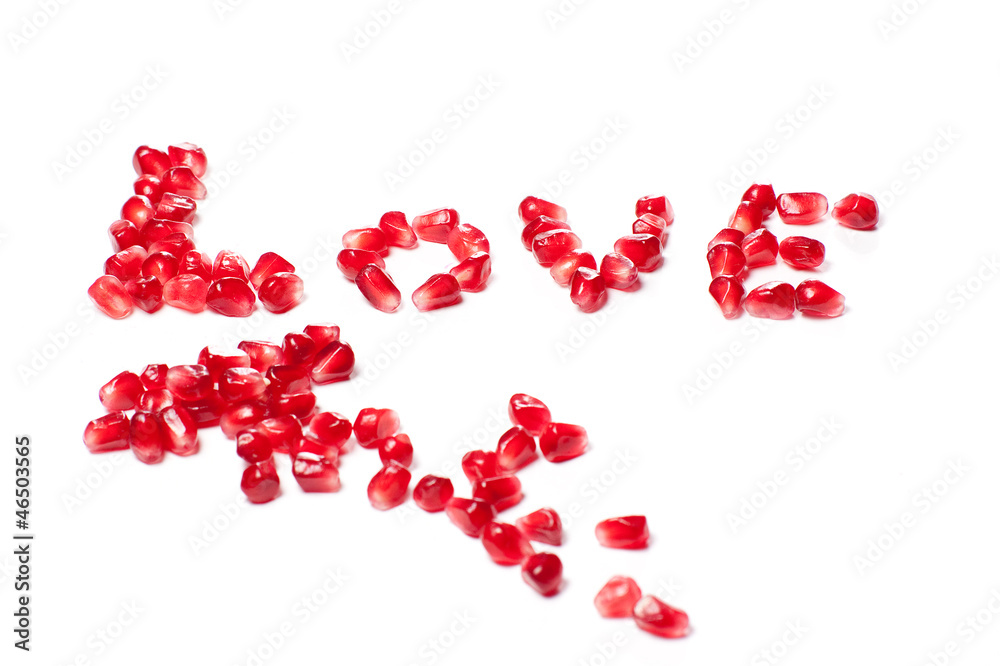 Word of love from the seeds of a pomegranate isolated on white Word of love from the seeds of a pomegranate isolated on white
