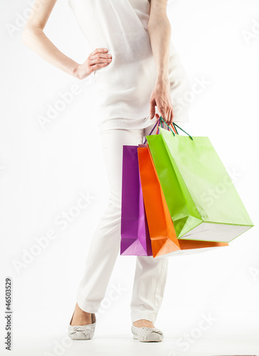Girl holding multicolored shopping paper bags