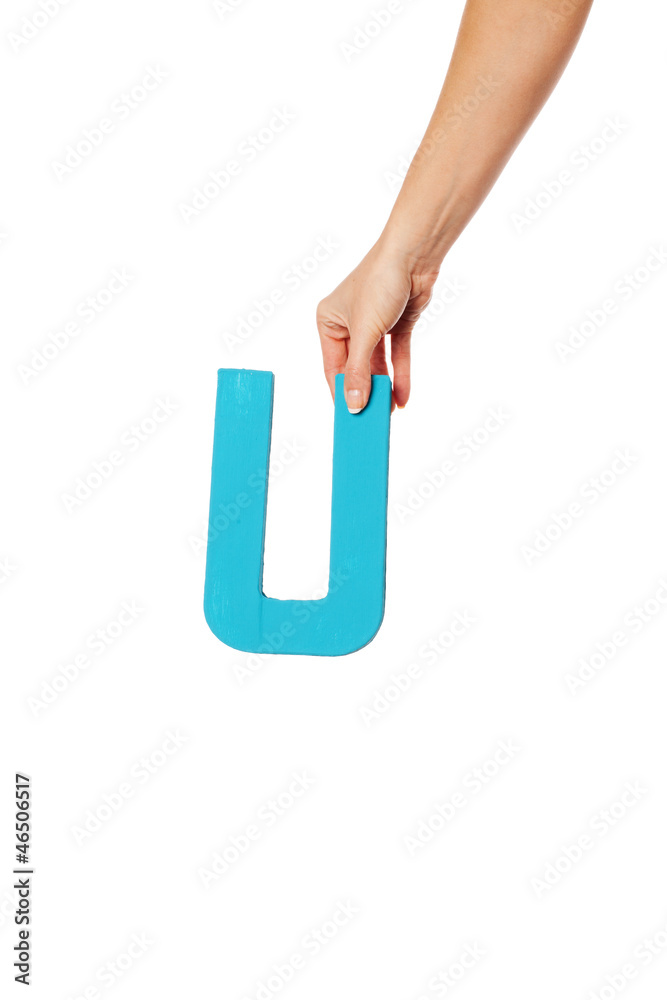hand holding up the letter U from the top hand holding up the letter U from the top
