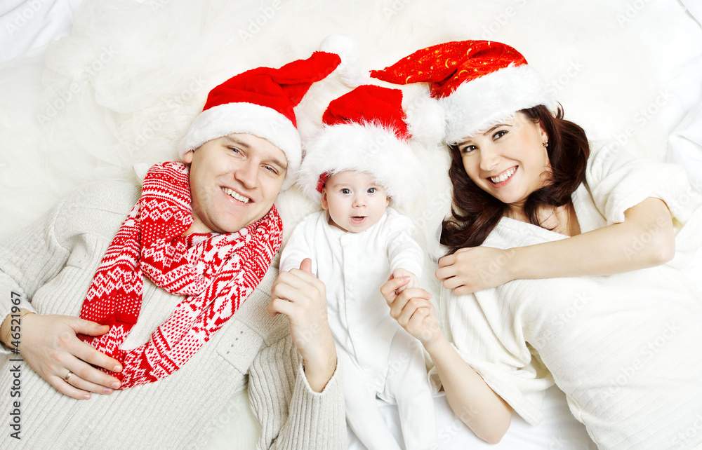 Christmas family of three persons in red hats Christmas family of three persons in red hats
