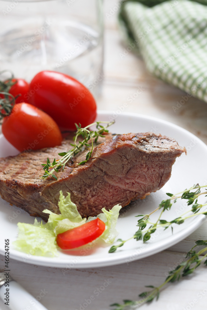 Beef steak with green salad and tomatoes Beef steak with green salad and tomatoes