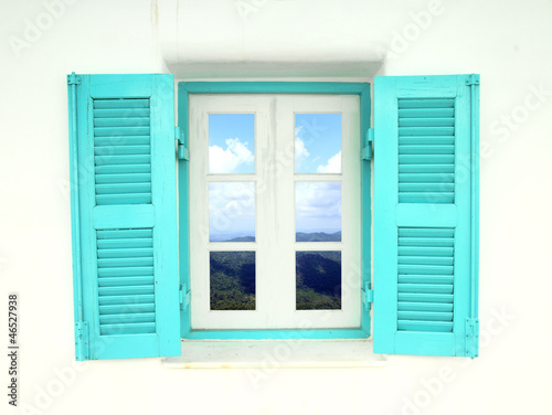 Greek style window with mountain and sky view