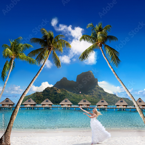 bride on a beach with palm and mountain. Bora-Bora. Polynesia
