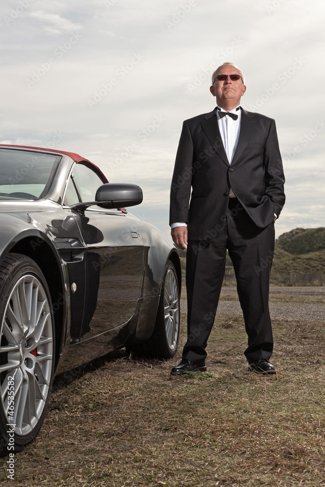 Senior good looking happy retired man with his sports car. Senior good looking happy retired man with his sports car.