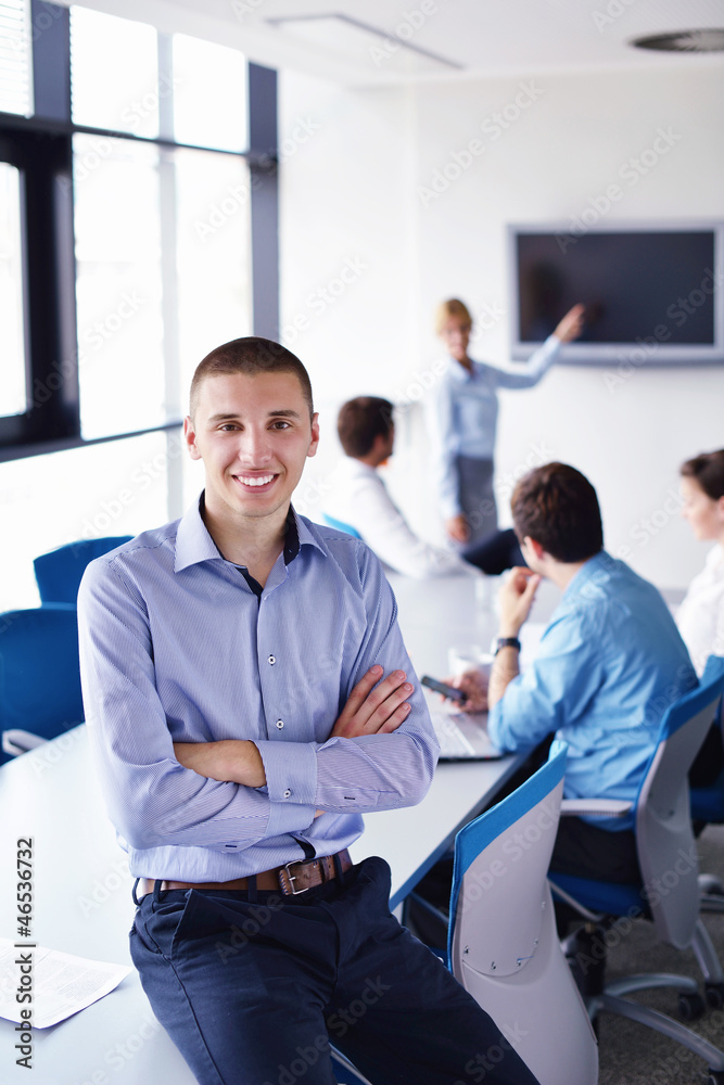 business man on a meeting in offce with colleagues in backgroun business man on a meeting in offce with colleagues in backgroun