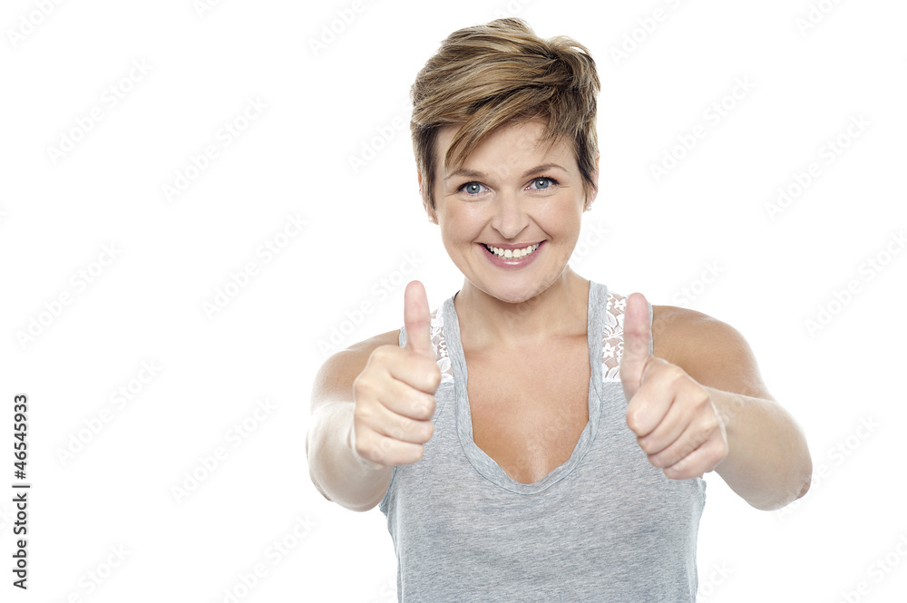 Excited middle aged lady showing double thumbs up Excited middle aged lady showing double thumbs up