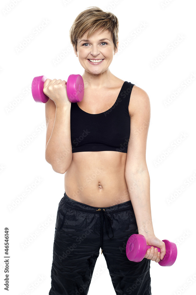 Cheerful middle-aged woman woman working out Cheerful middle-aged woman woman working out