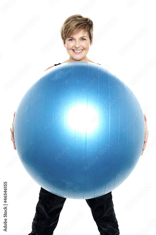 Charming woman holding big blue fitness ball Charming woman holding big blue fitness ball