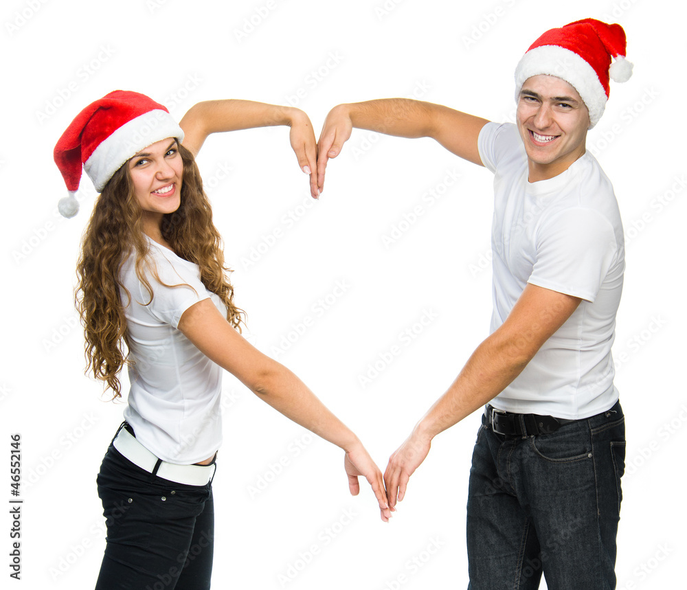 Beautiful Christmas couple in Santa hats Beautiful Christmas couple in Santa hats