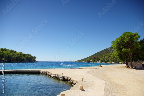 Concrete empty beach in the bay of turquoise sea  Croatia