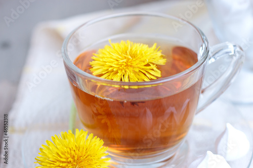 tea in glass cup and flowers