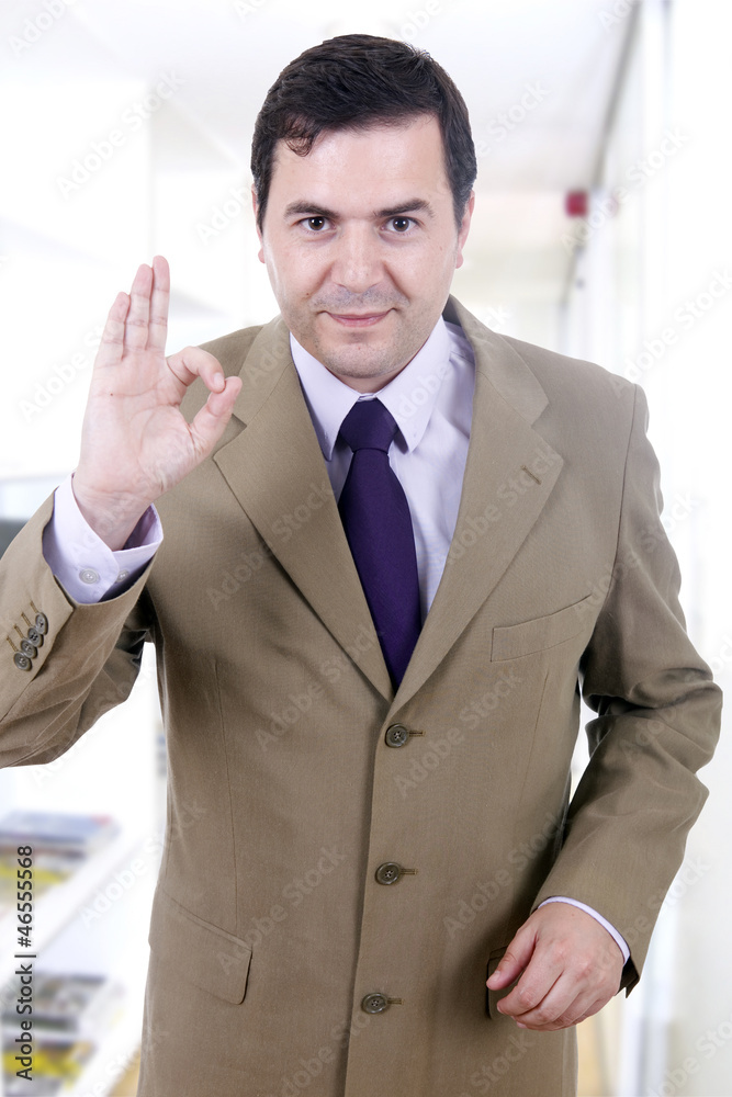 A young handsome happy business man gesturing success at office A young handsome happy business man gesturing success at office