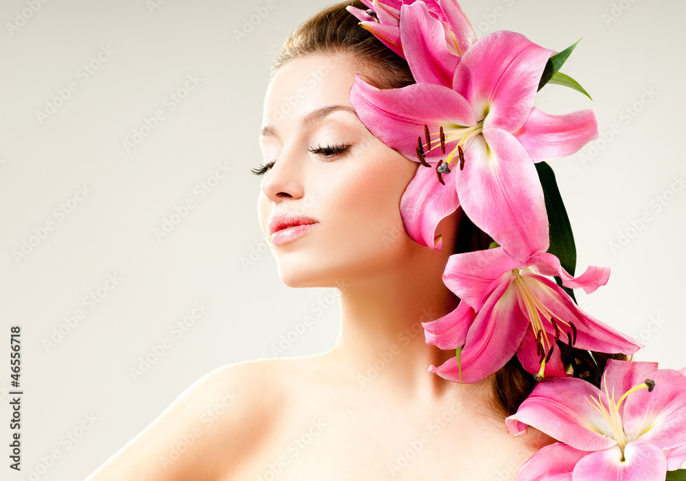 beautiful girl with pink lilies in her hair beautiful girl with pink lilies in her hair