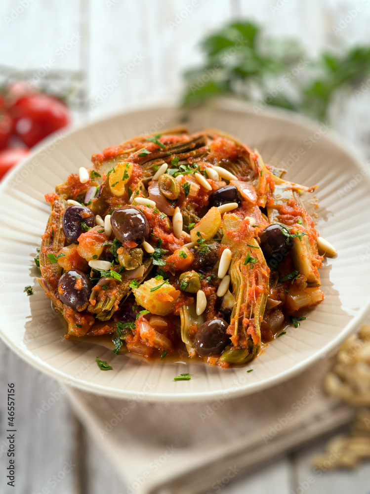 caponata with atichoke and pine nuts, selective focus caponata with atichoke and pine nuts, selective focus