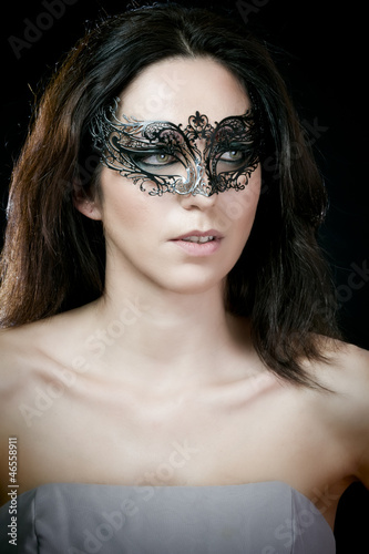 close-up portrait of sexy brunette woman with carnival venetian photo