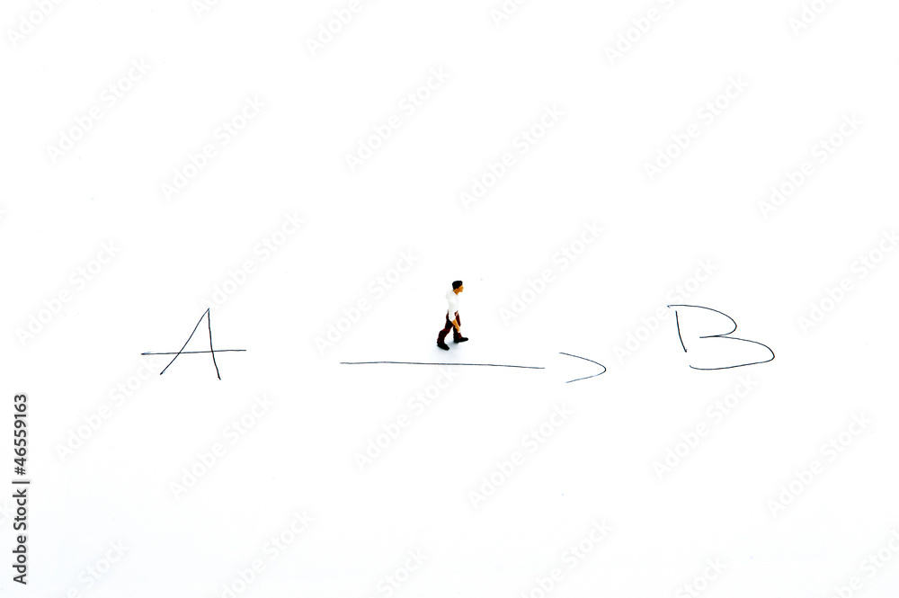 Miniature people on white with some diagrams Miniature people on white with some diagrams