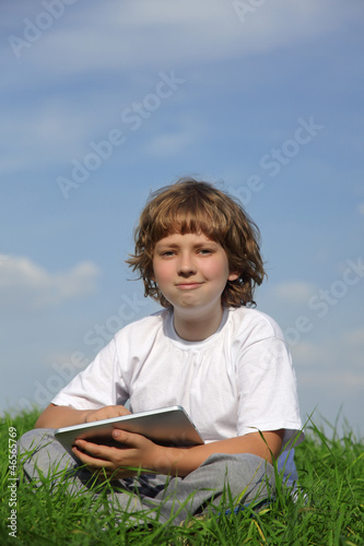 Boy with tablet pc outdoors © Chepko Danil
