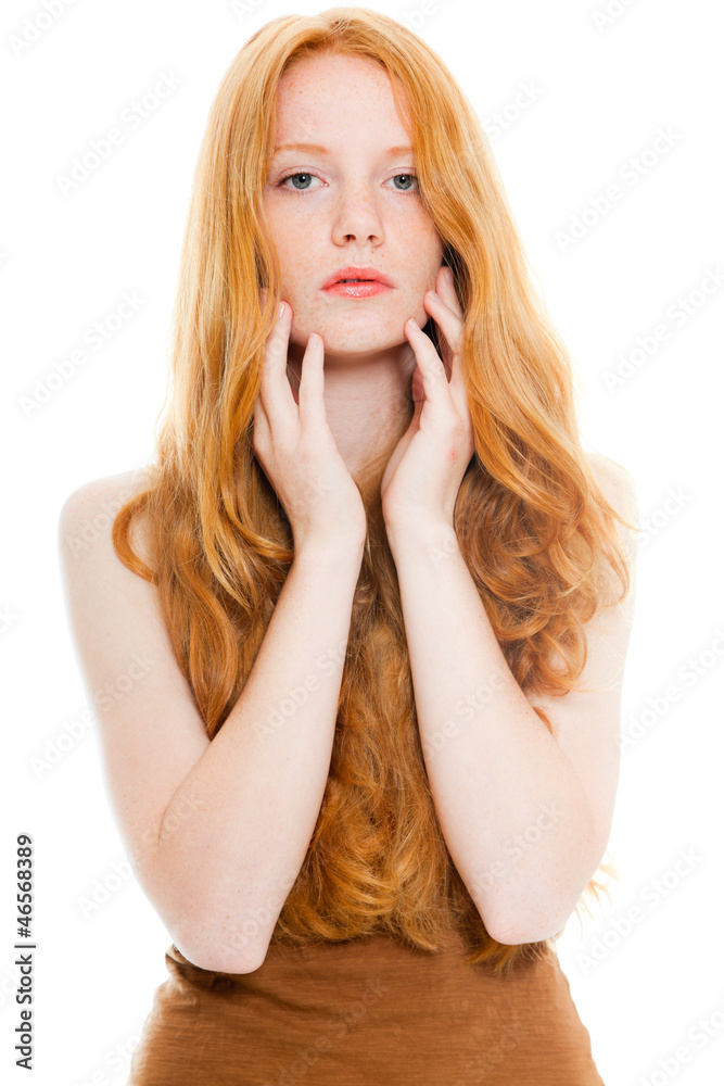 Pretty fashion girl with long red hair against white background.